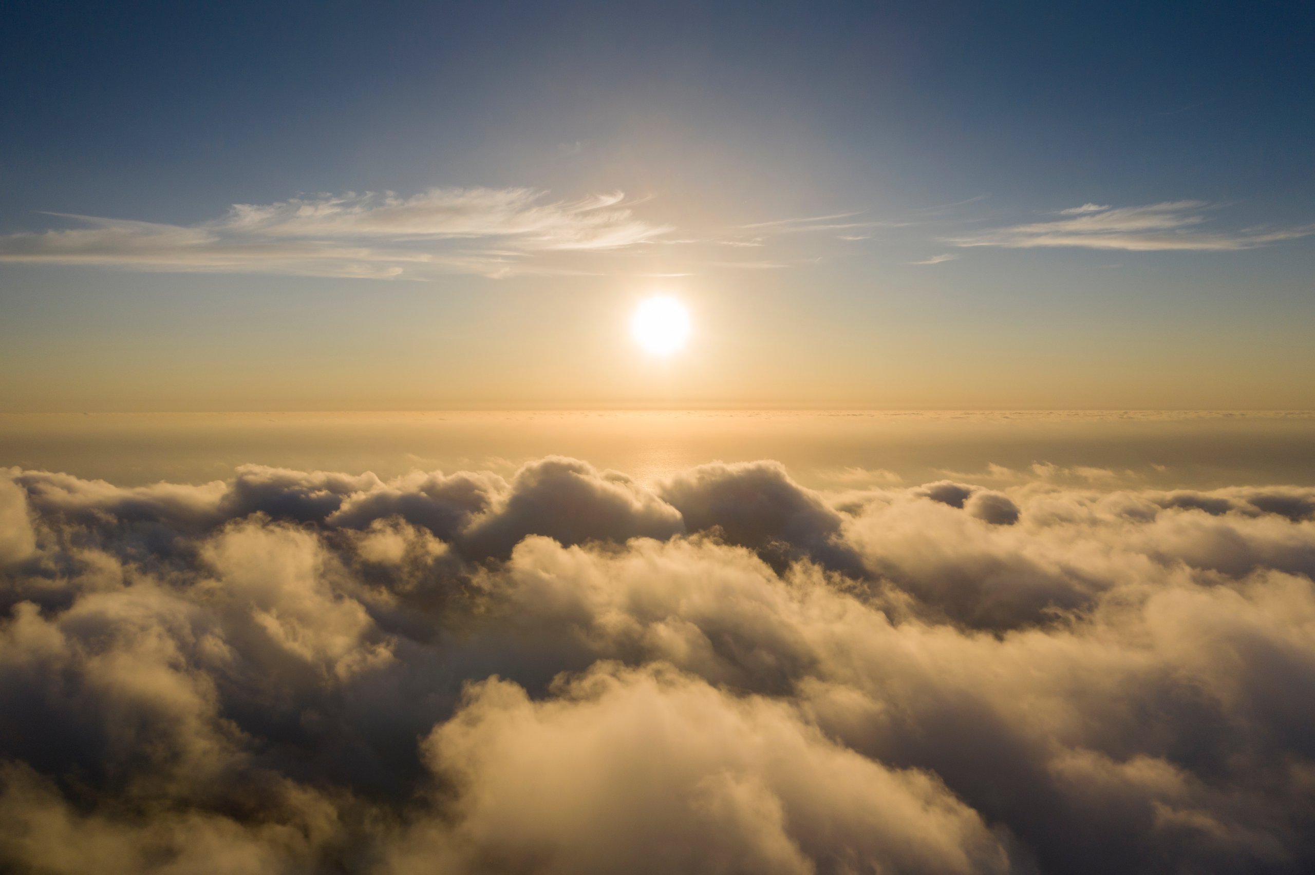 Peaceful sunrise above clouds representing transcendence and peace